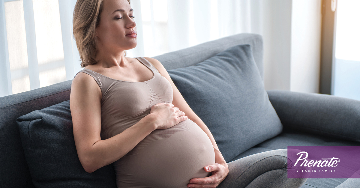 Pregnant women deep breathing on couch