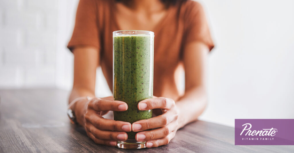 Woman holding green smoothie